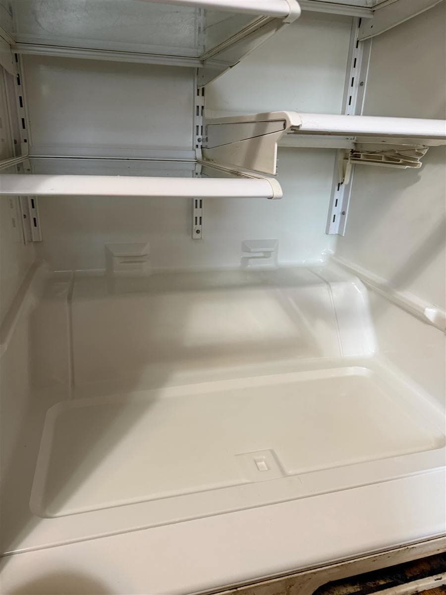 A refrigerator interior caked with spilled food residue restored to a spotless, empty shine by a New Jersey house cleaning crew.