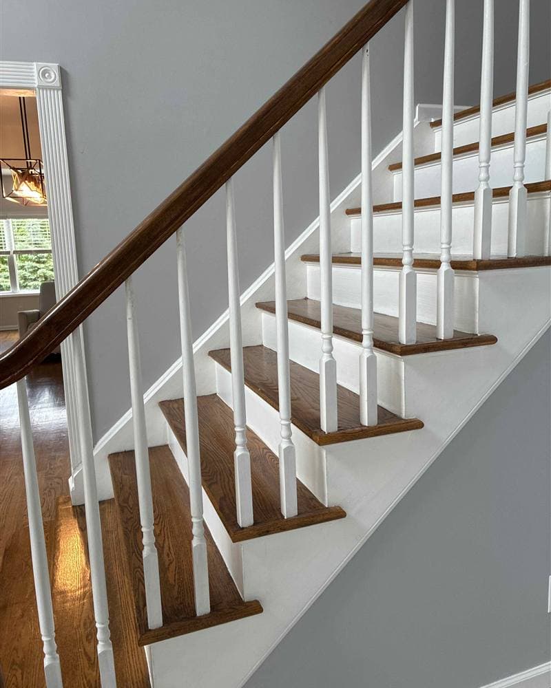 Dusted and polished wooden staircase with white risers and balusters in a Jefferson, NJ home