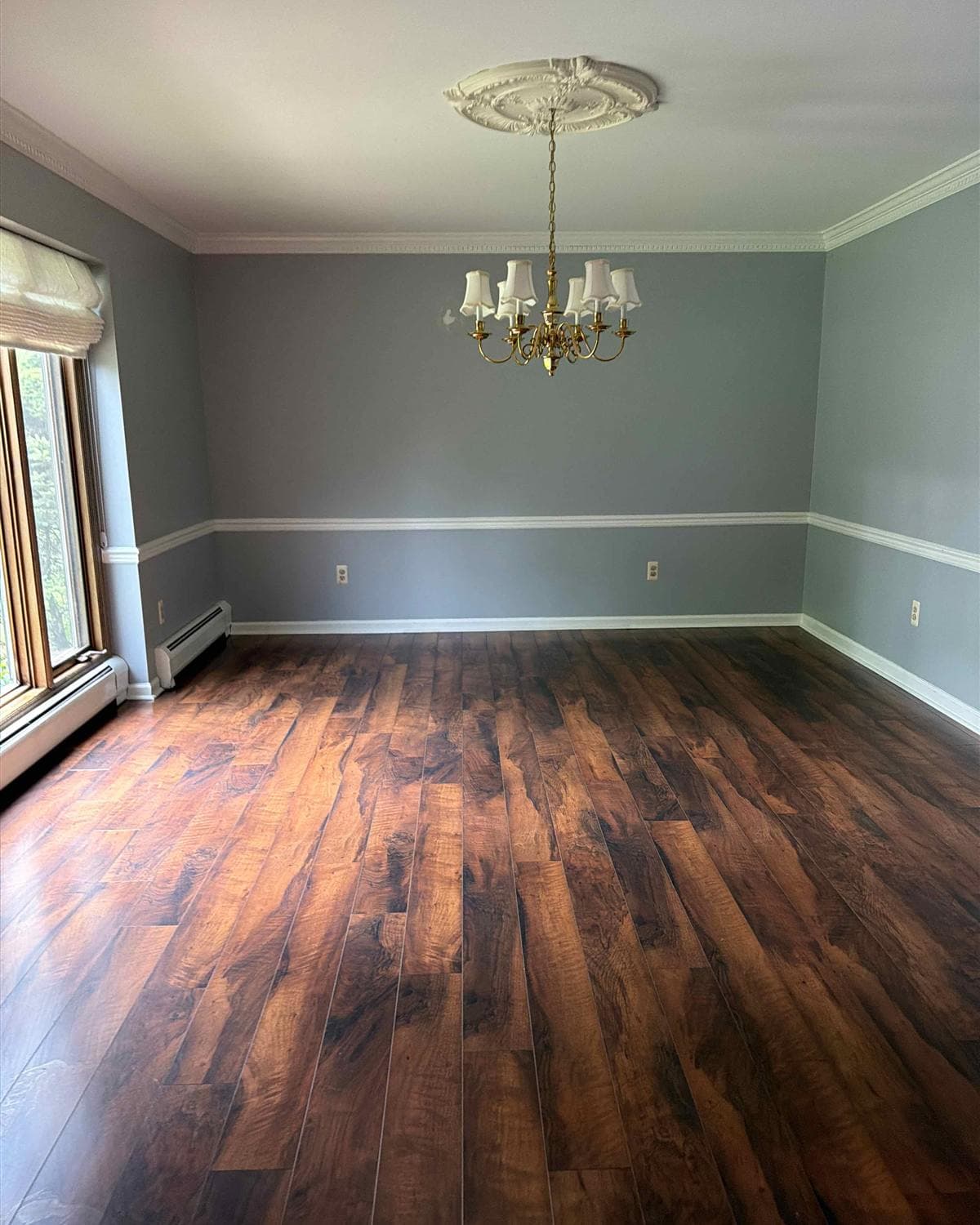 Freshly cleaned dining room with polished hardwood floors and chandelier in Roxbury, NJ